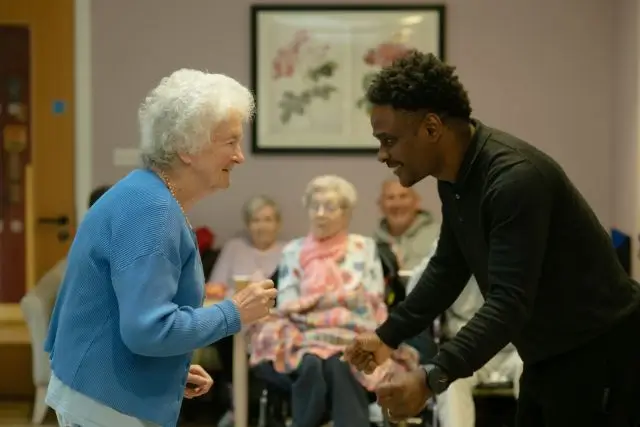 Caregiver providing attentive one-on-one support to an elderly resident